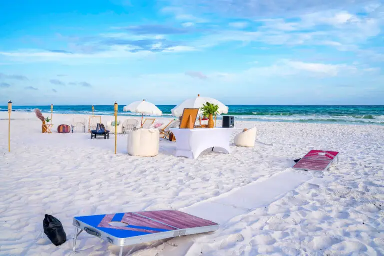 A beachside bonfire setup in Santa Rosa Beach along 30A featuring wooden cornhole boards on the sand.