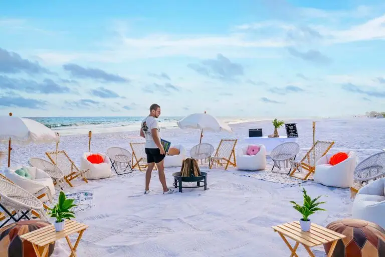 Setting up a luxury beachside bonfire along 30A with lounge chairs, umbrellas, and bean bags on the sand.